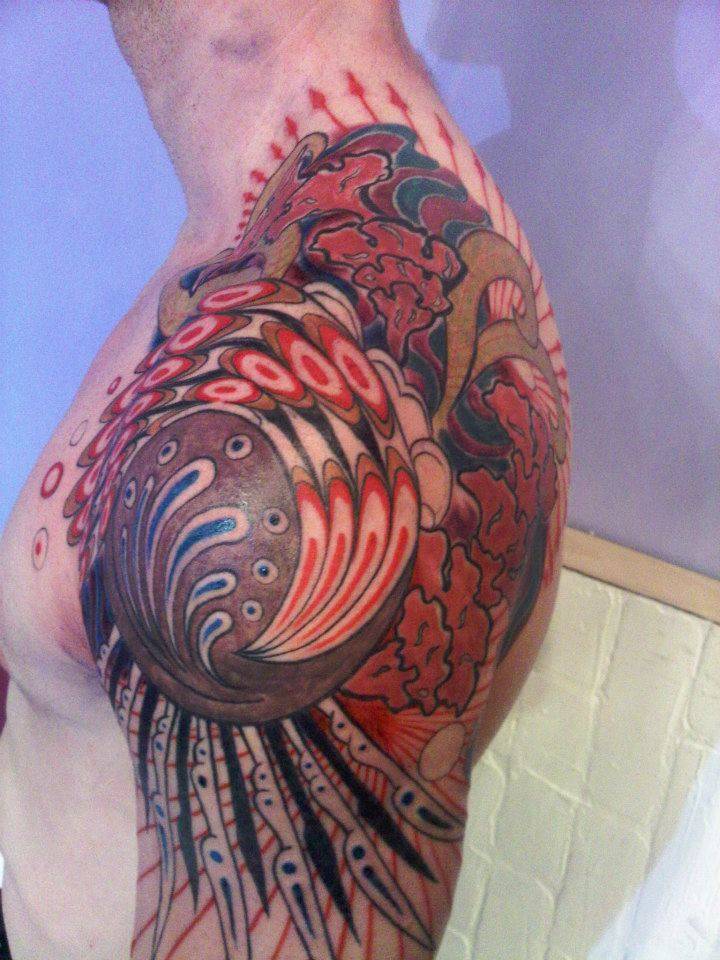 red and black shoulder tattoo